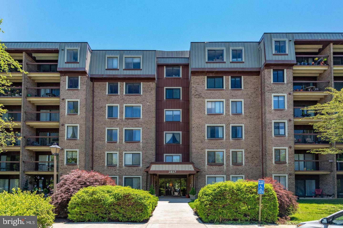 2817 Jermantown Road, Unit 107 Oakton, VA 22124 - Photo 25 of 28 a front view of multi story residential apartment building
