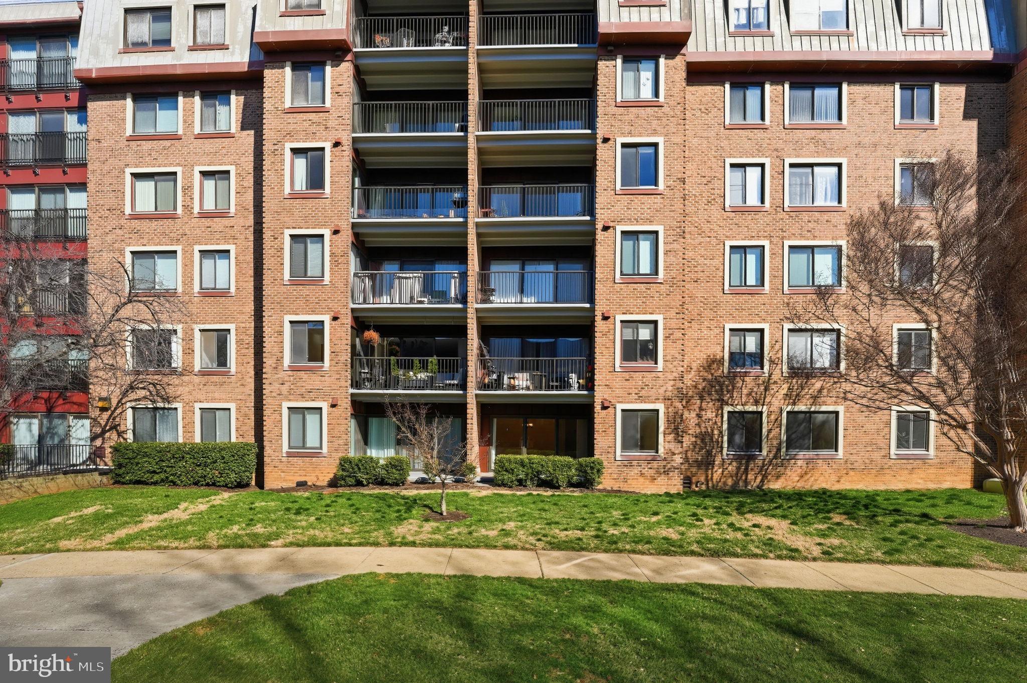 2817 Jermantown Road, Unit 107 Oakton, VA 22124 - Photo 27 of 28 a brick building with a yard in front of it