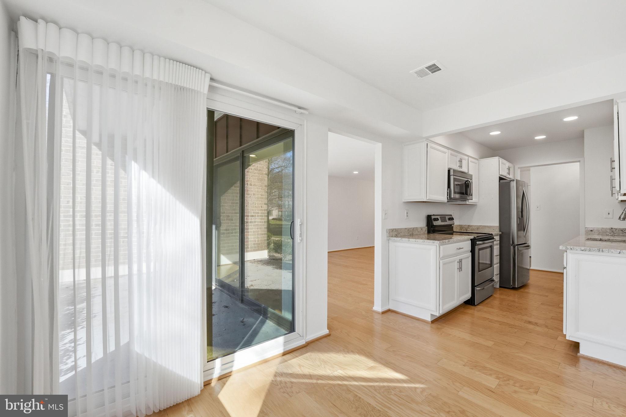 2817 Jermantown Road, Unit 107 Oakton, VA 22124 - Photo 3 of 28 a kitchen with a refrigerator and a sink