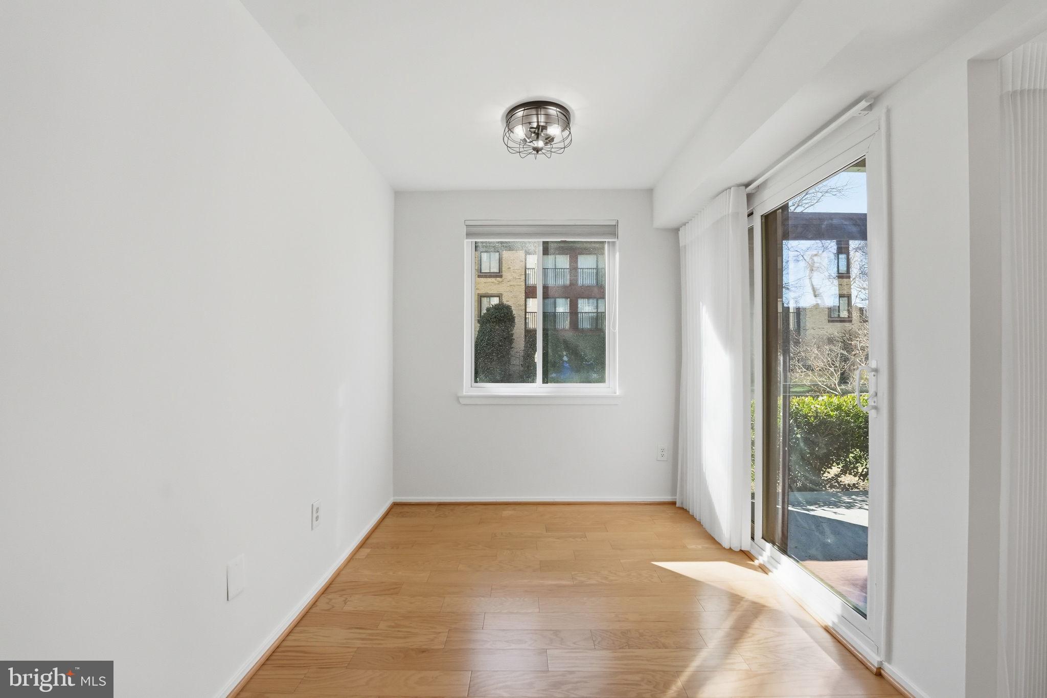 2817 Jermantown Road, Unit 107 Oakton, VA 22124 - Photo 6 of 28 a view of an empty room with a window