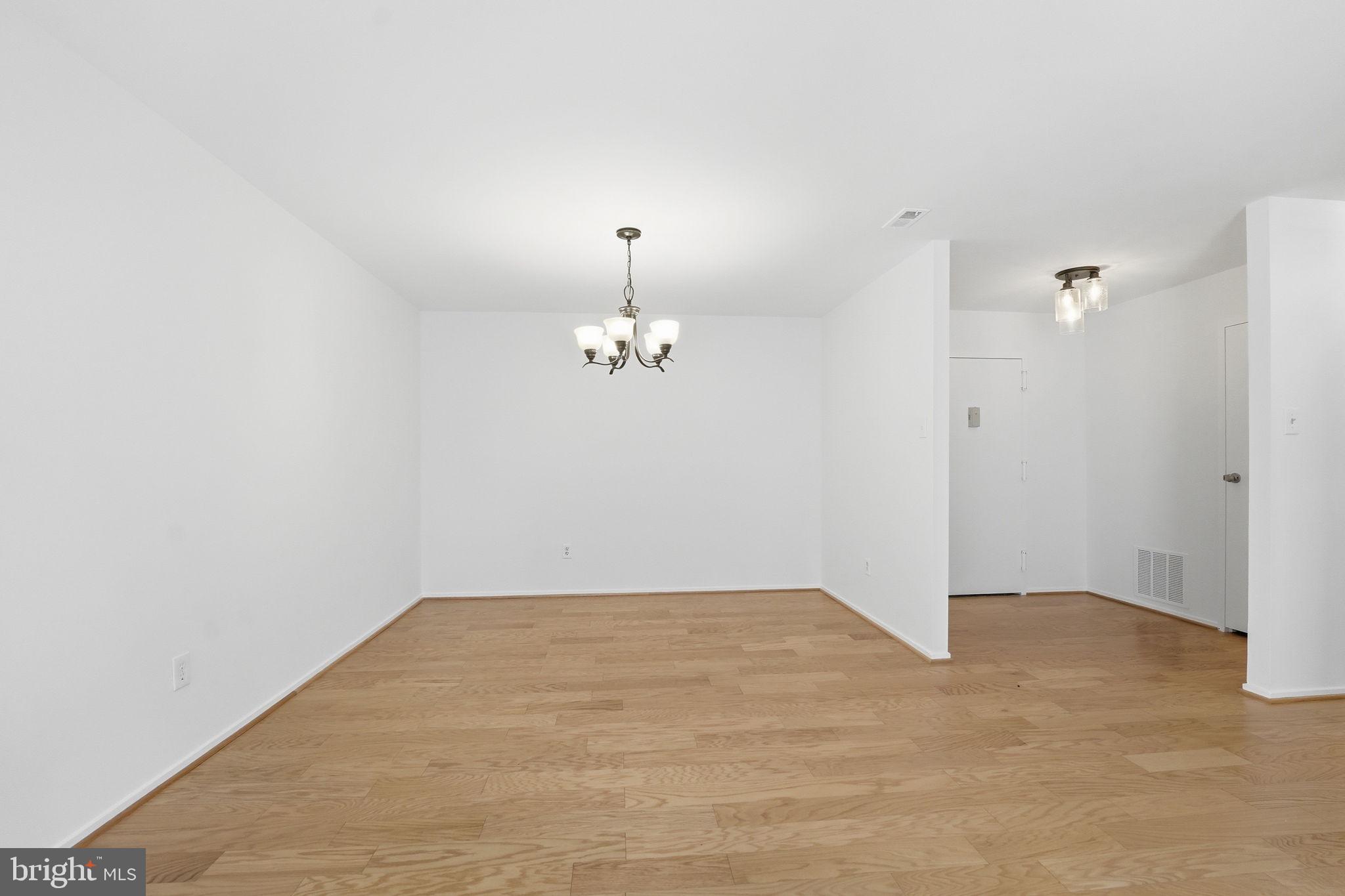 2817 Jermantown Road, Unit 107 Oakton, VA 22124 - Photo 8 of 28 wooden floor in an empty room