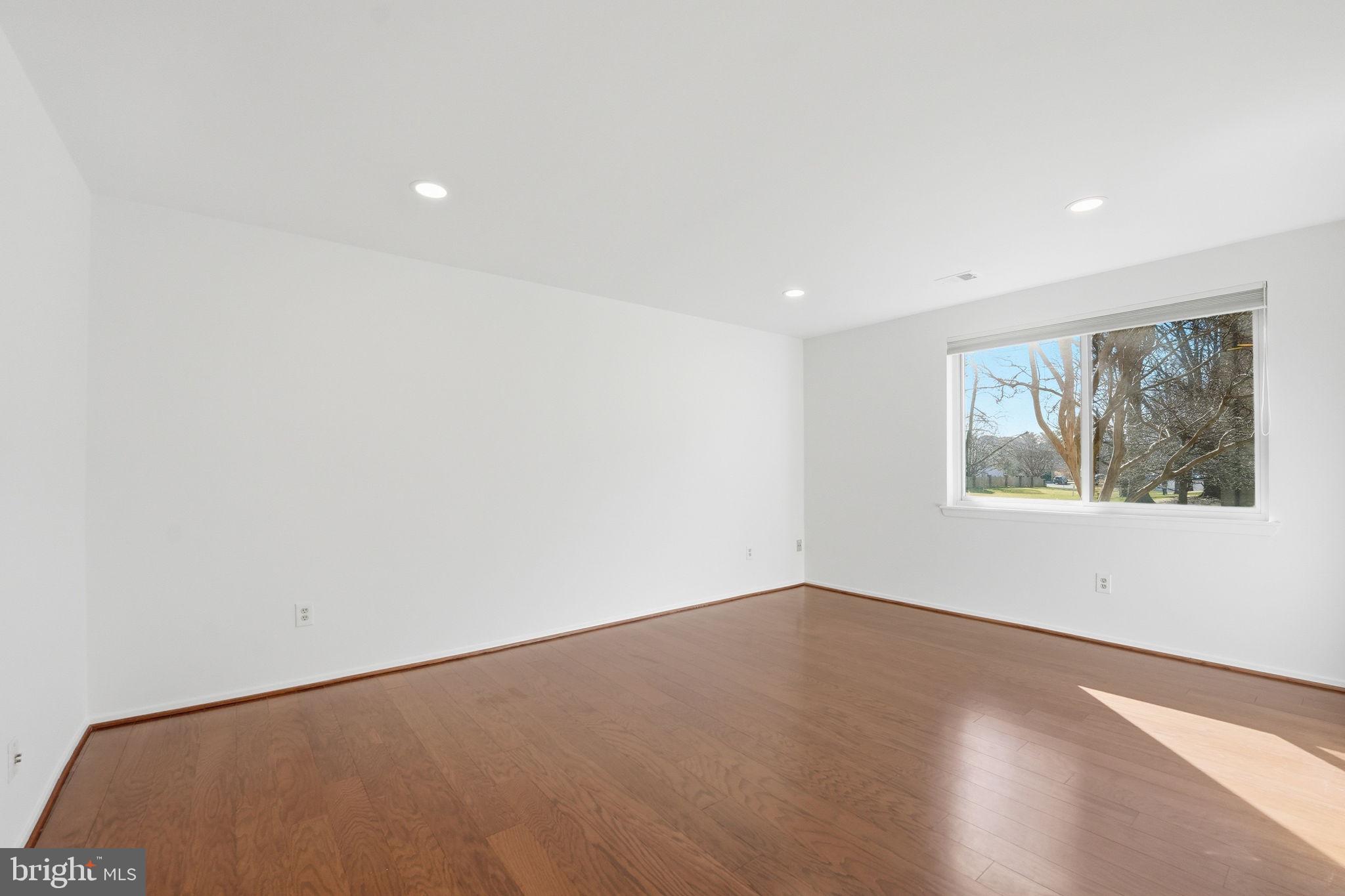 2817 Jermantown Road, Unit 107 Oakton, VA 22124 - Photo 10 of 28 an empty room with wooden floor and windows