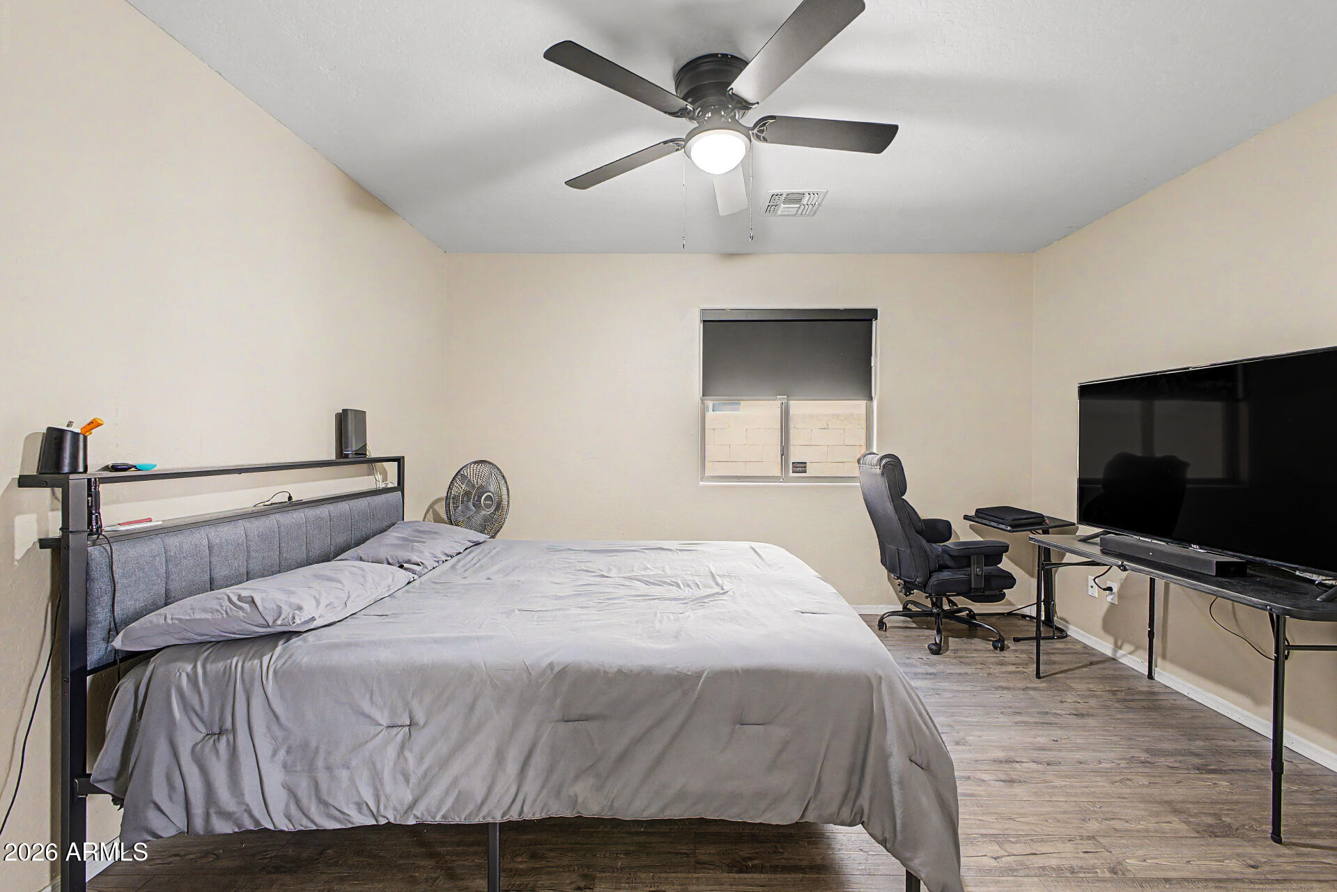 2340 West Apollo Road Phoenix, AZ 85041 - Photo 18 of 26 a bedroom with a bed and a flat screen tv