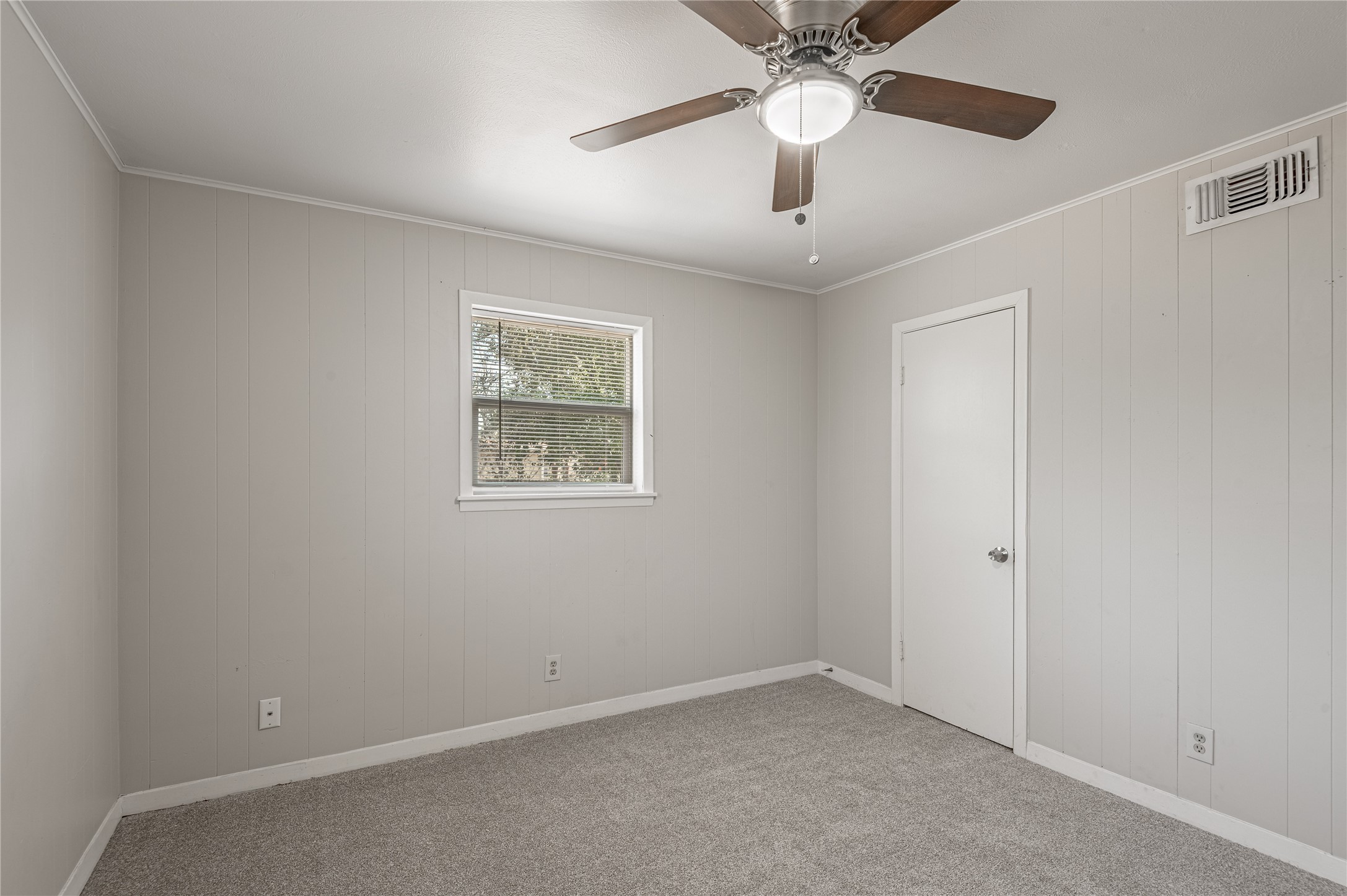 525 12th Street, Unit 7 Huntsville, TX 77340 - Photo 12 of 21 an empty room with a chandelier fan and windows