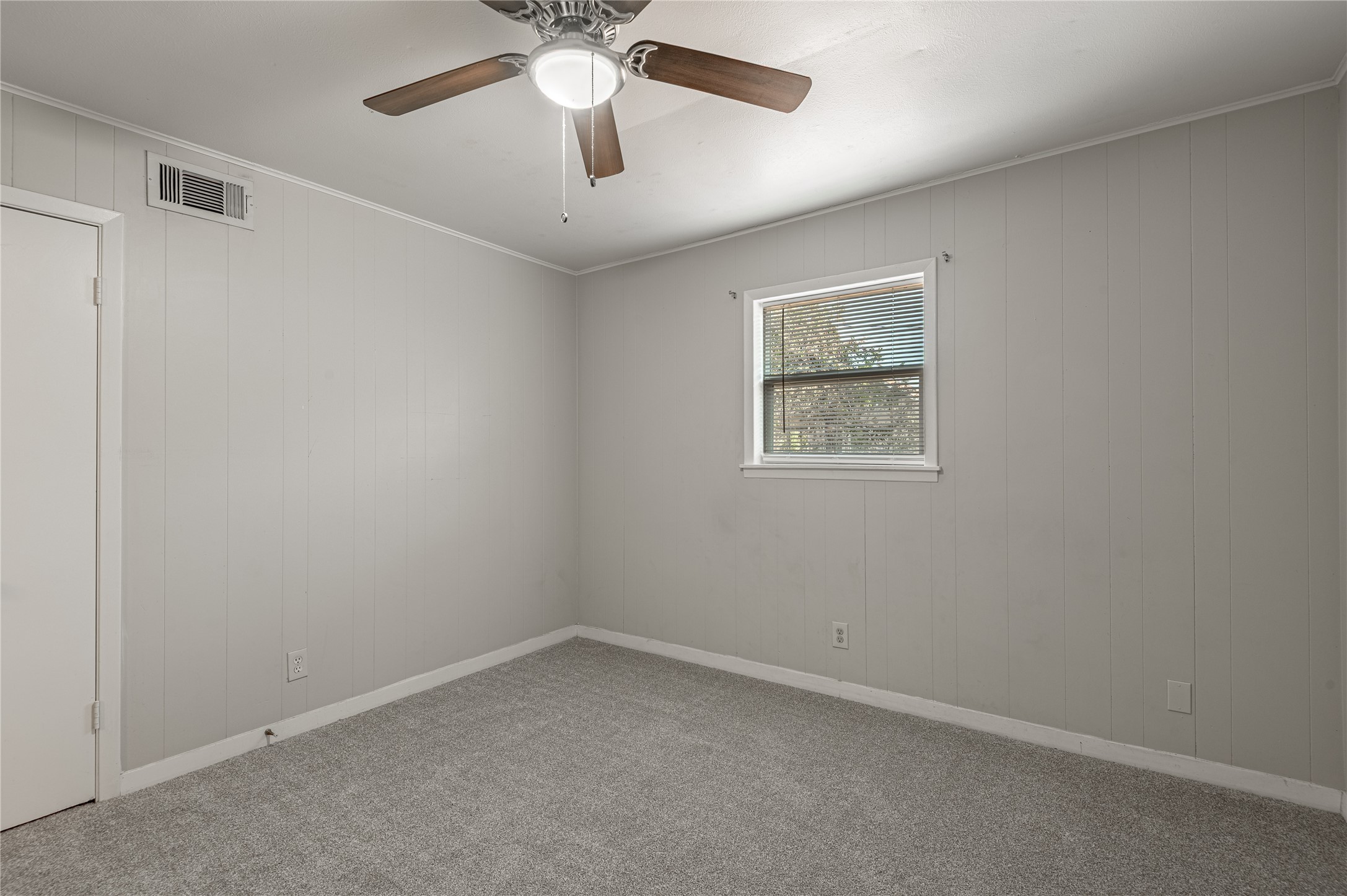 525 12th Street, Unit 7 Huntsville, TX 77340 - Photo 16 of 21 an empty room with a window and a fan
