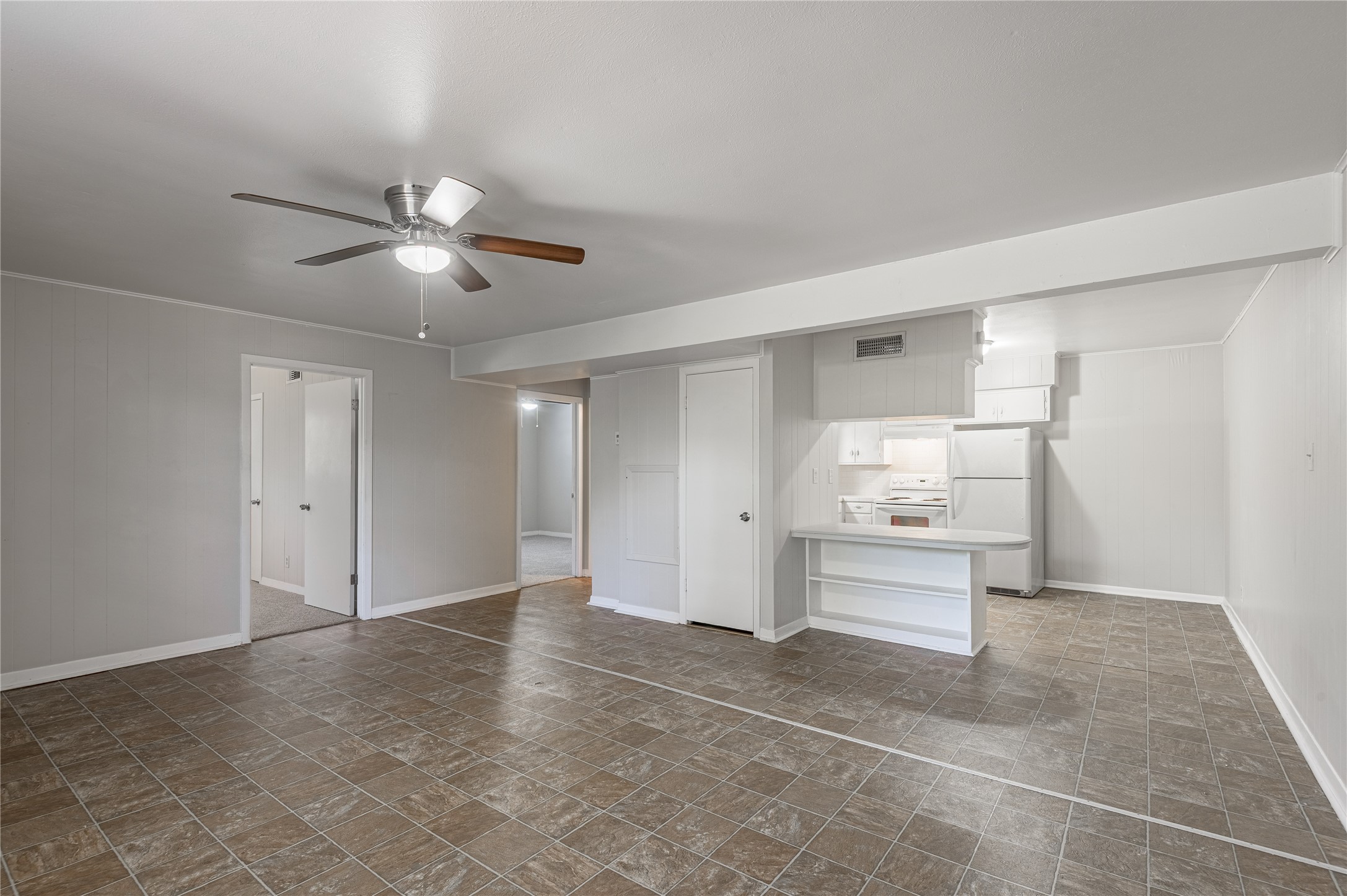 525 12th Street, Unit 7 Huntsville, TX 77340 - Photo 3 of 21 a view of a kitchen with a sink and a refrigerator