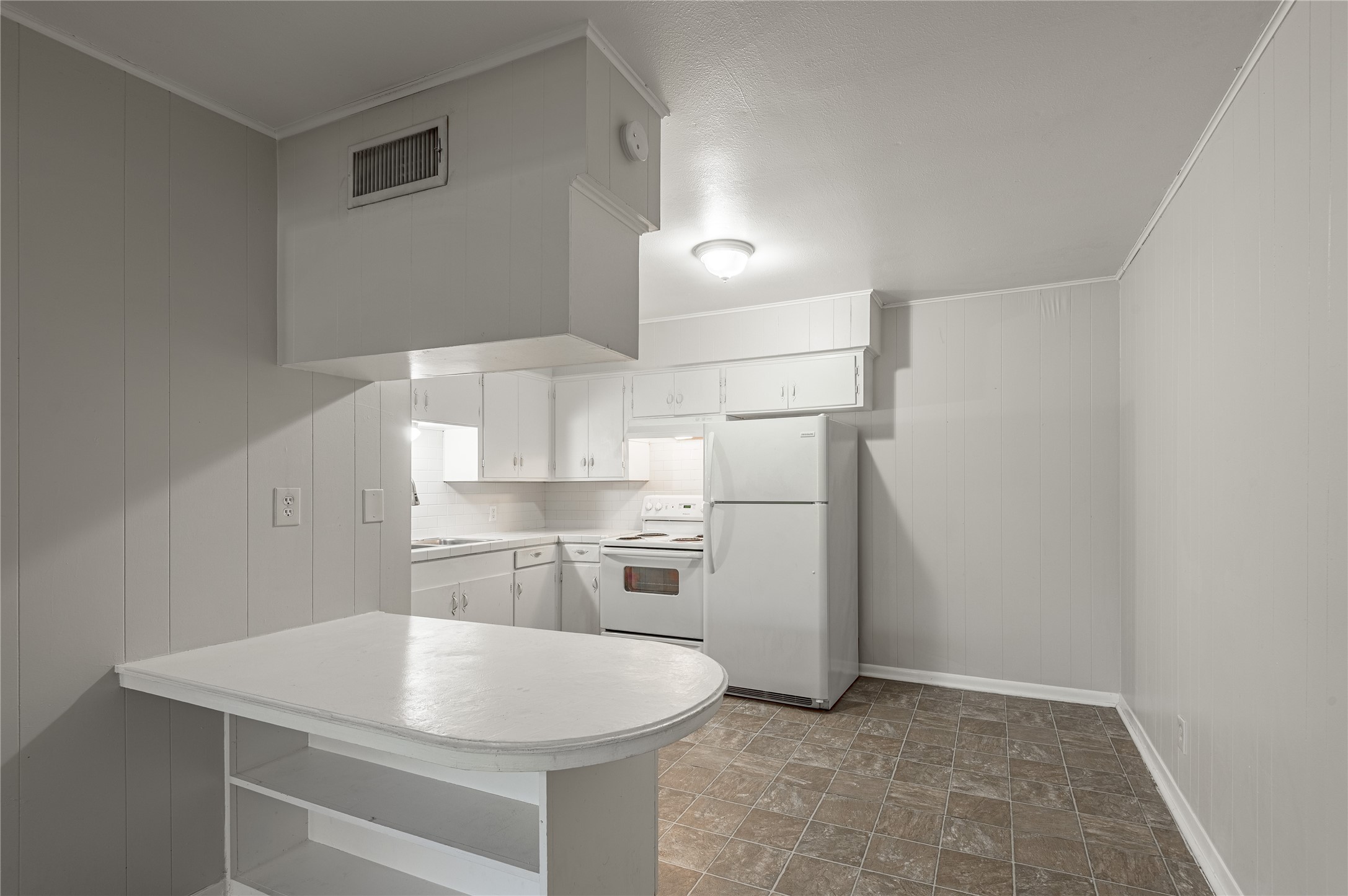 525 12th Street, Unit 7 Huntsville, TX 77340 - Photo 7 of 21 a kitchen with stainless steel appliances a refrigerator and microwave