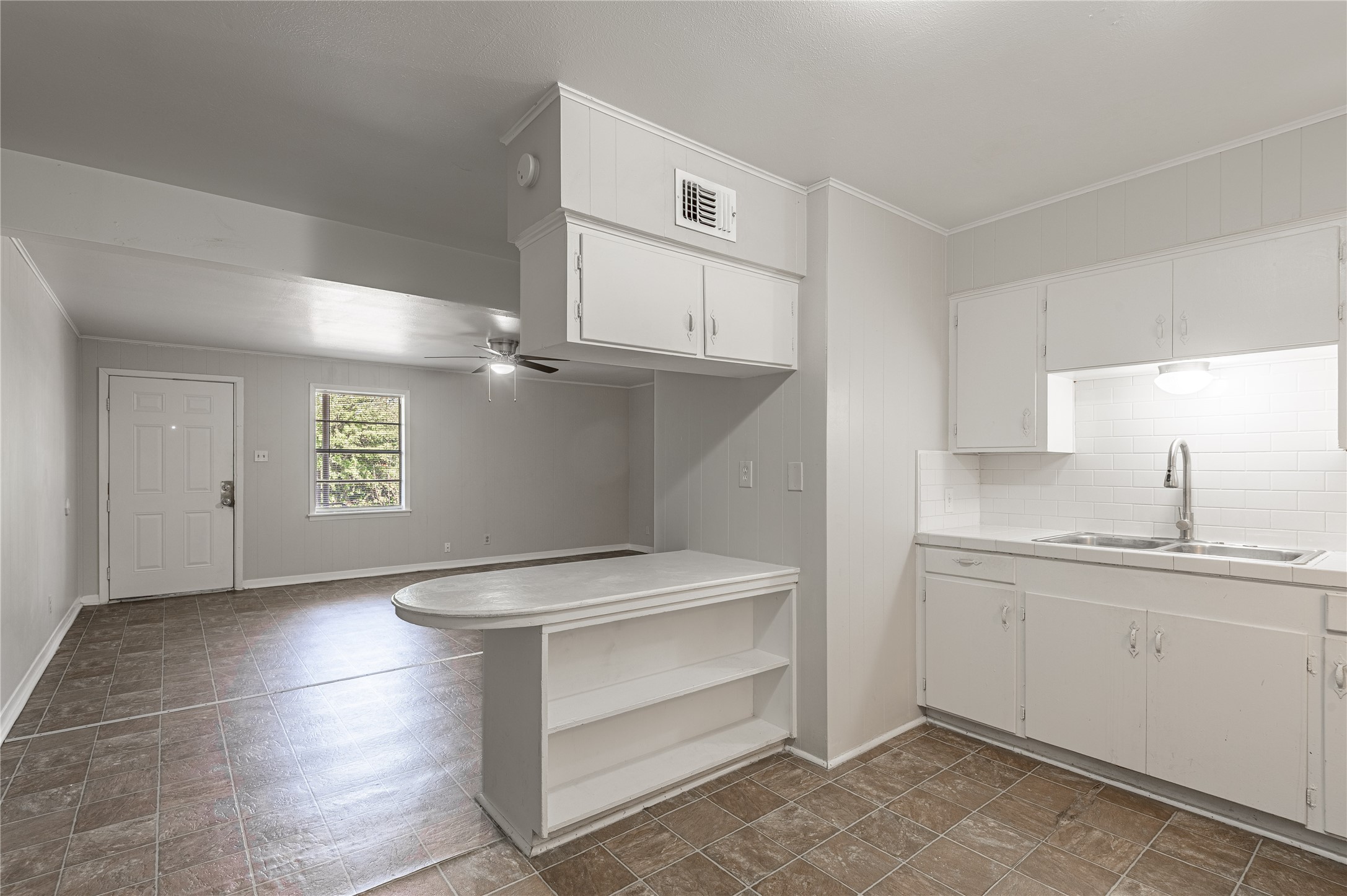 525 12th Street, Unit 7 Huntsville, TX 77340 - Photo 8 of 21 a kitchen with white cabinets and sink
