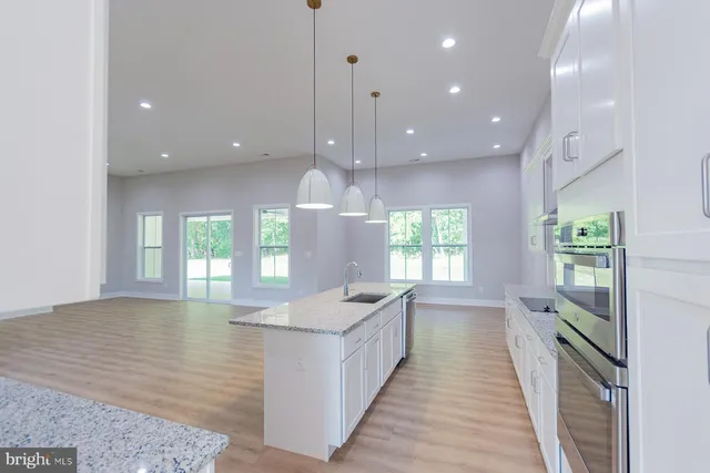 a kitchen with granite countertop cabinets and steel stainless steel appliances