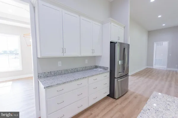 a kitchen with granite countertop a stove a sink and a granite counter top