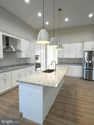 a large kitchen with stainless steel appliances kitchen island a large island in the center and a sink