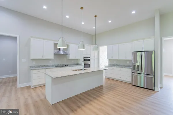 a large kitchen with a large counter top appliances and cabinets