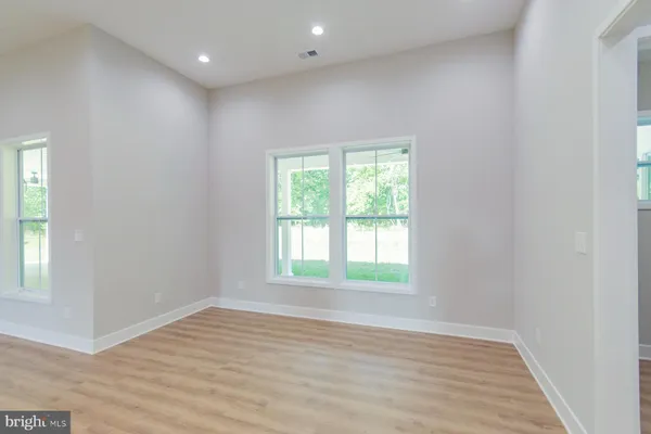 a view of an empty room with a fireplace and a window