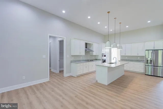 a view of an empty room with a fireplace and a window