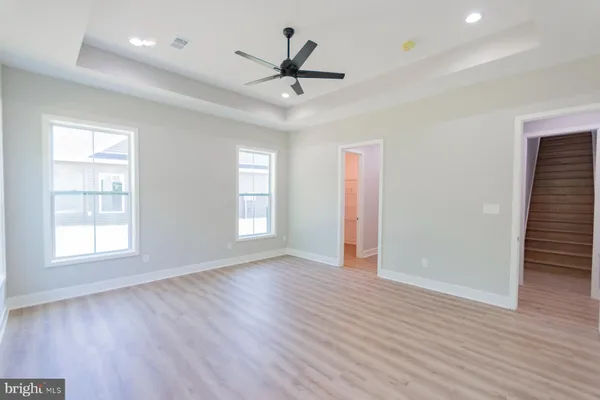 a bathroom with a granite countertop sink and white cabinets