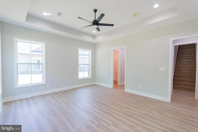 a bathroom with a granite countertop sink and white cabinets