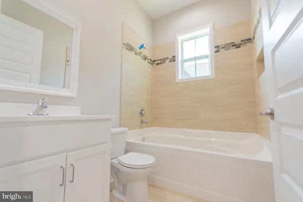 a view of a livingroom with a ceiling fan and window