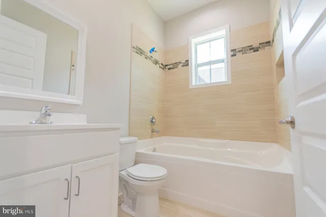 a view of a livingroom with a ceiling fan and window