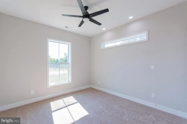 a view of a livingroom with a ceiling fan and window