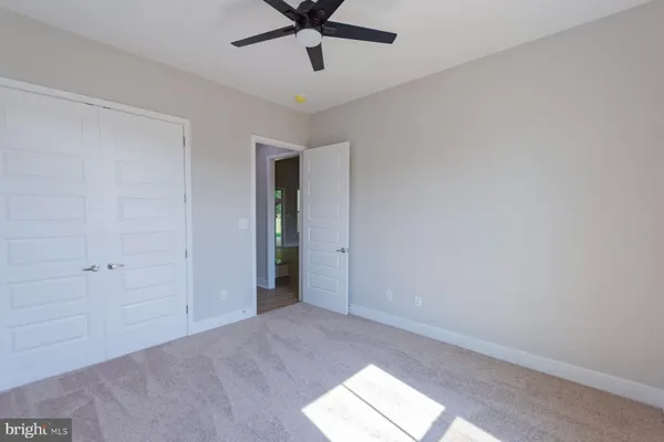a view of a house with a big yard and large trees