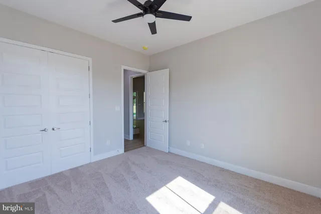 a view of a house with a big yard and large trees
