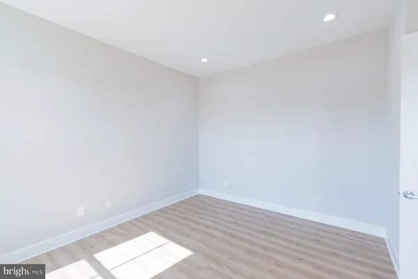 a view of a room with wooden floor chandeliers and window