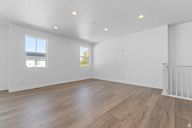 3016 West 2650 North Clinton, UT 84015 - Photo 13 of 20 Empty room featuring wood-type flooring and recessed lighting
