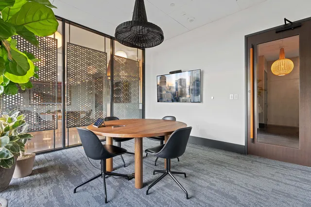 a living room with furniture a rug and a chandelier
