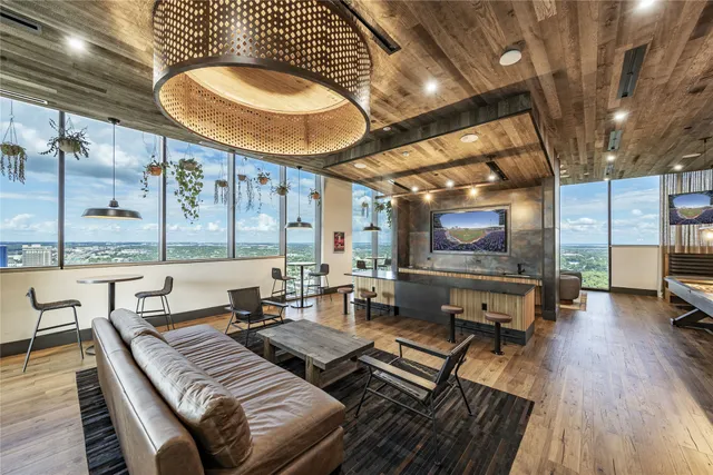 a living room with couches a fireplace and a flat screen tv