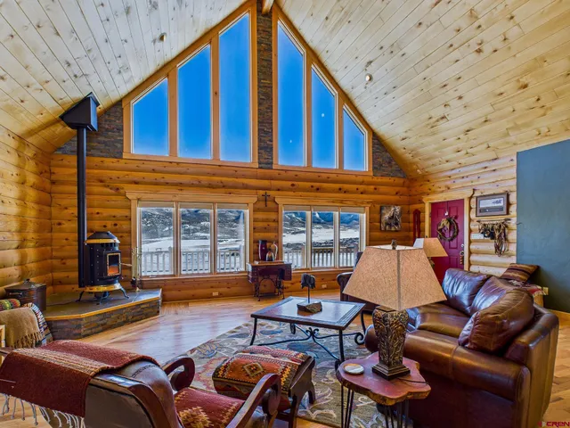 a living room with furniture a fireplace and a table