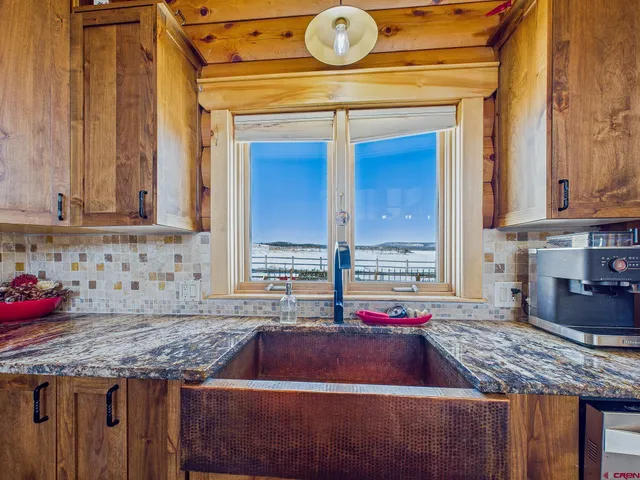 a view of a dining room with furniture and window