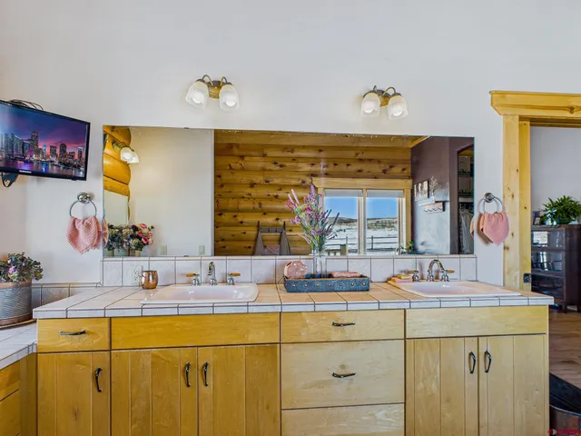 a bathroom with a bathtub sink and mirror