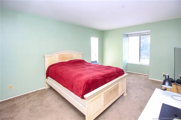 a spacious bedroom with a bed and window