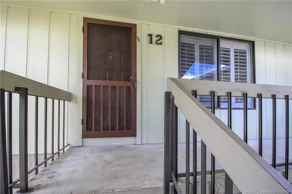 a view of staircase with railing and a window