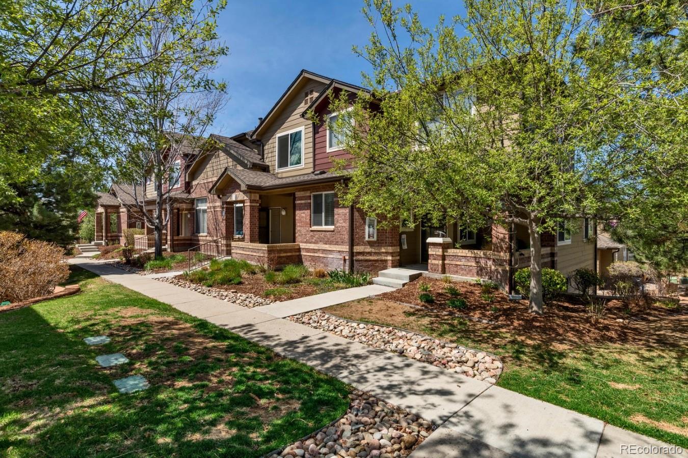 6486 Silver Mesa Drive, Unit B Highlands Ranch, CO 80130 - Photo 1 of 29 a front view of a house with garden