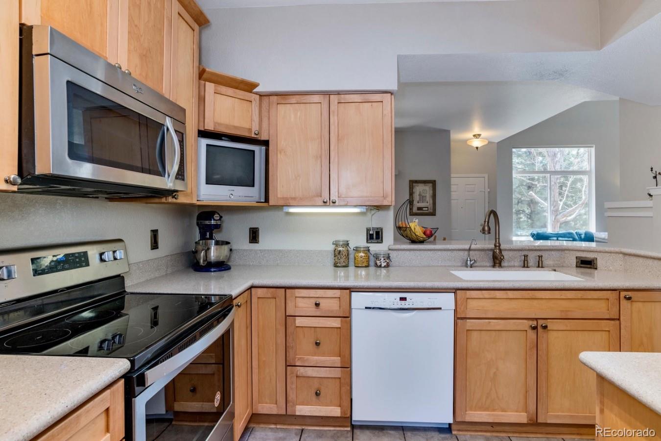 6486 Silver Mesa Drive, Unit B Highlands Ranch, CO 80130 - Photo 11 of 29 a kitchen with a sink stove and microwave