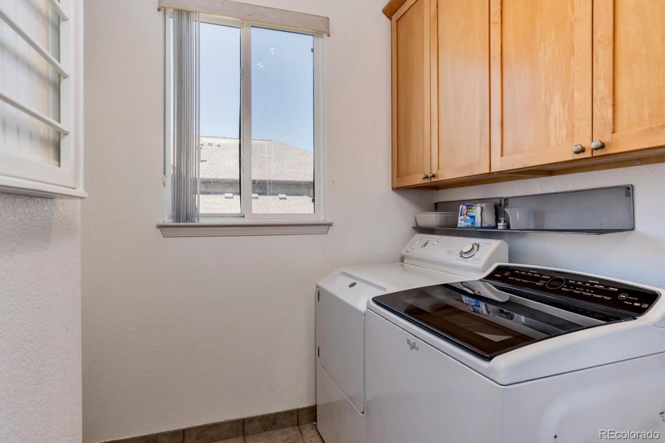6486 Silver Mesa Drive, Unit B Highlands Ranch, CO 80130 - Photo 12 of 29 a kitchen with wooden cabinets and a stove top oven