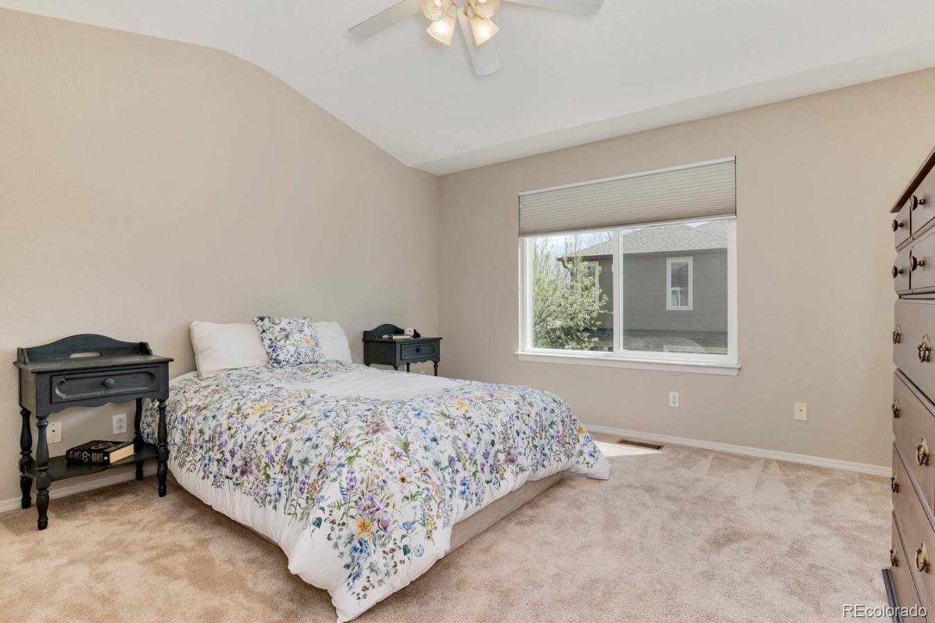 6486 Silver Mesa Drive, Unit B Highlands Ranch, CO 80130 - Photo 15 of 29 a bedroom with a bed and a window