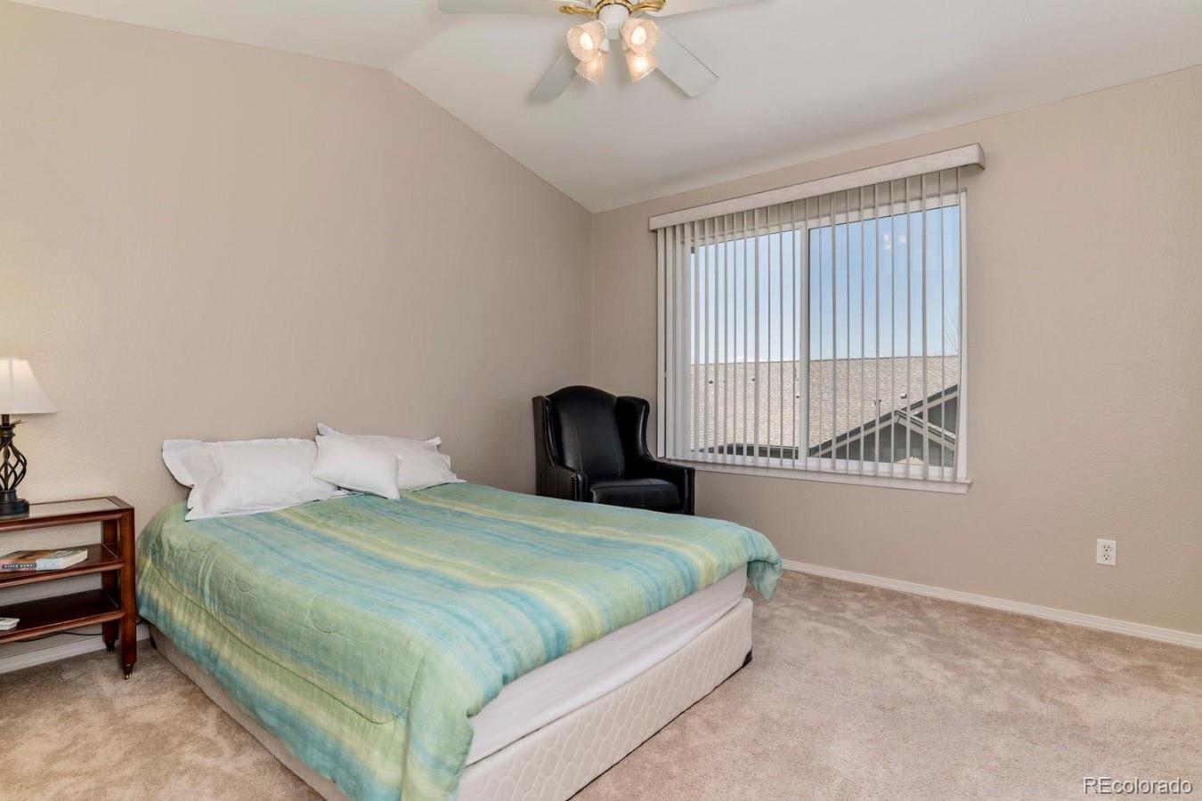 6486 Silver Mesa Drive, Unit B Highlands Ranch, CO 80130 - Photo 18 of 29 a bedroom with a bed and a chandelier
