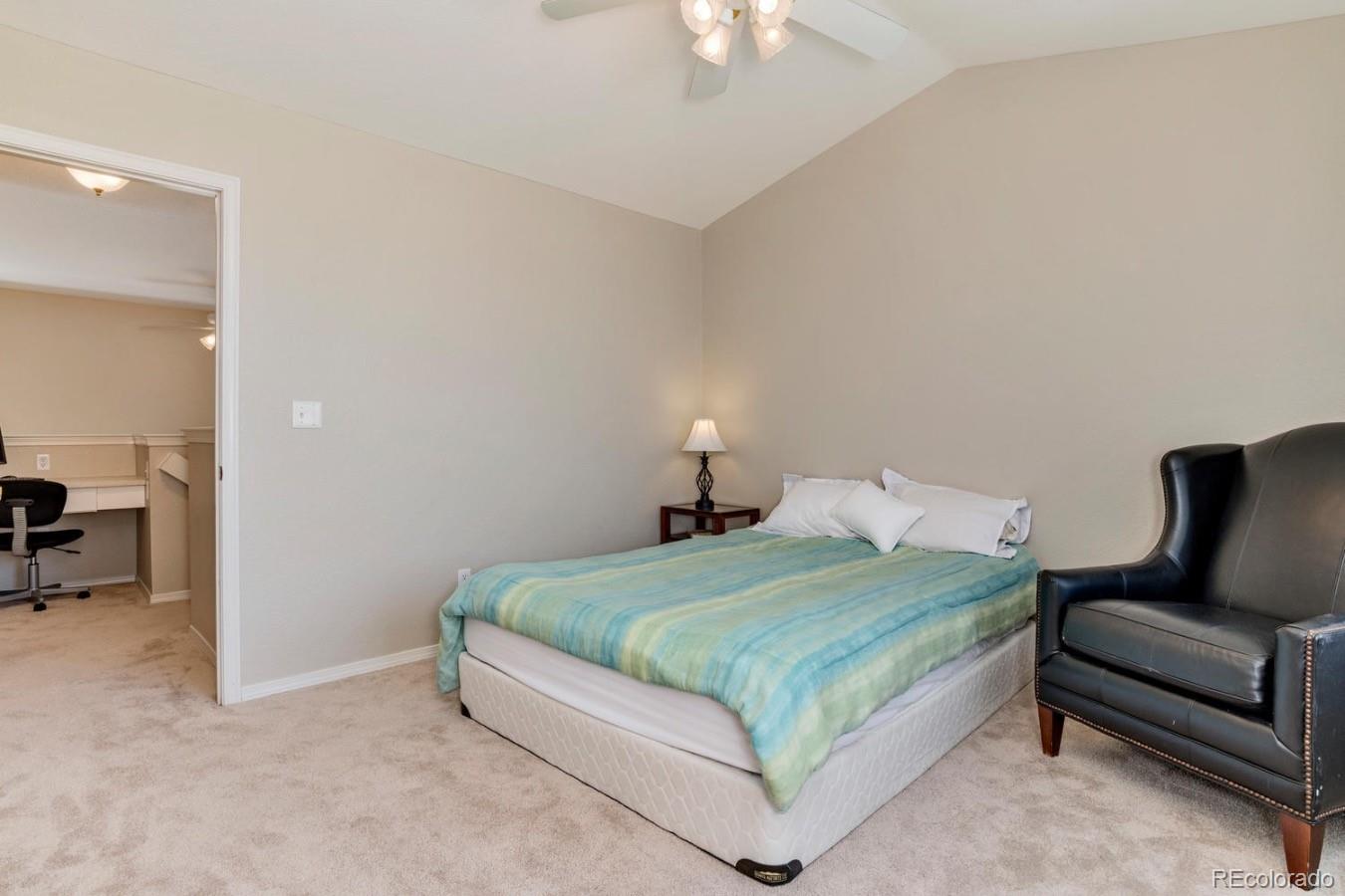 6486 Silver Mesa Drive, Unit B Highlands Ranch, CO 80130 - Photo 19 of 29 a bedroom with a bed and a chair