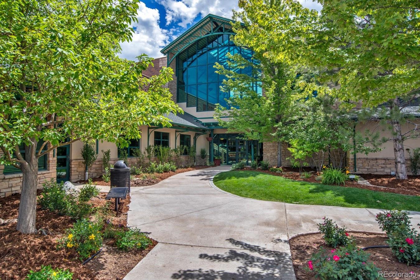 6486 Silver Mesa Drive, Unit B Highlands Ranch, CO 80130 - Photo 24 of 29 a front view of a house with a garden and outdoor seating