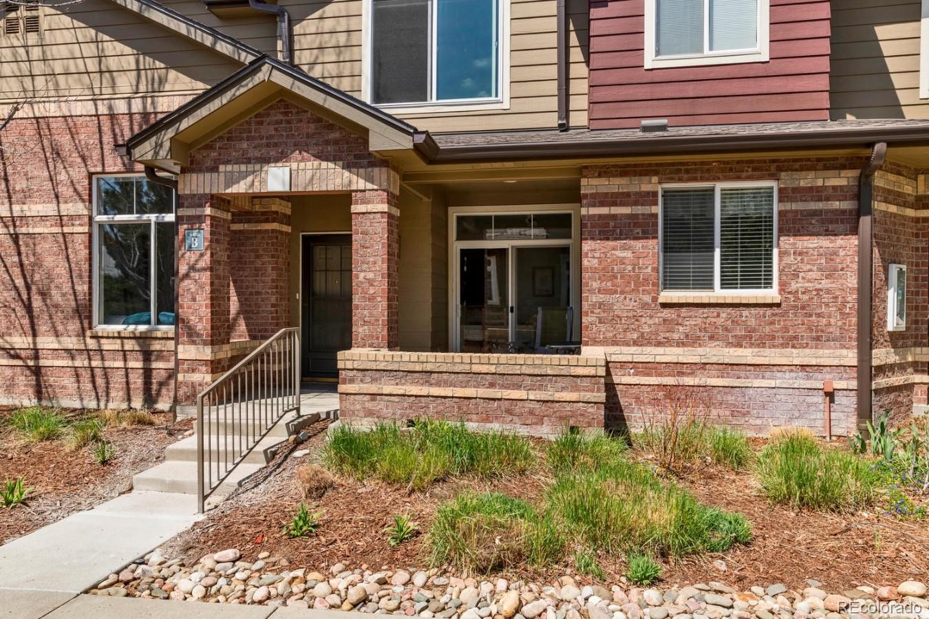 6486 Silver Mesa Drive, Unit B Highlands Ranch, CO 80130 - Photo 3 of 29 front view of a house with a yard