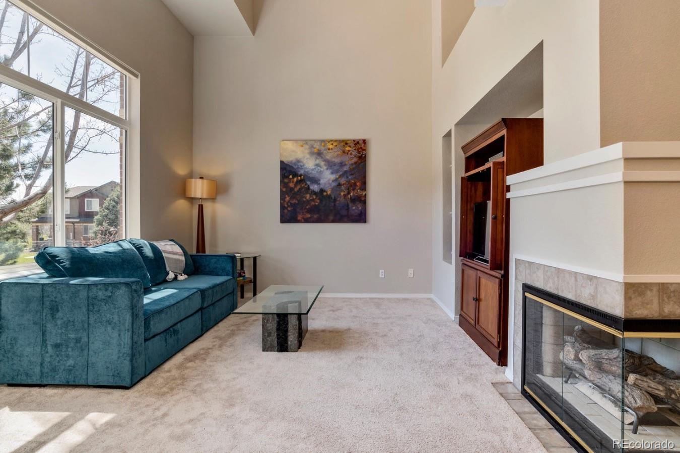 6486 Silver Mesa Drive, Unit B Highlands Ranch, CO 80130 - Photo 4 of 29 a living room with furniture and a fireplace