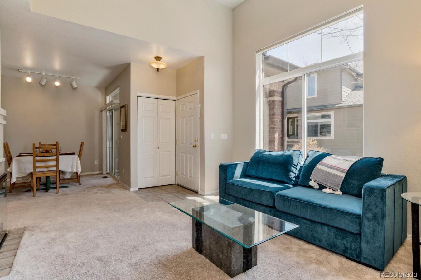 6486 Silver Mesa Drive, Unit B Highlands Ranch, CO 80130 - Photo 5 of 29 a living room with furniture and a chandelier