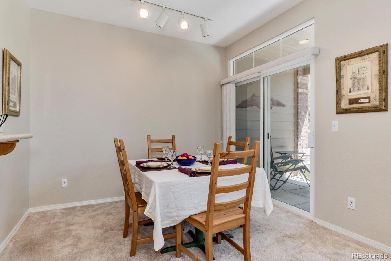 6486 Silver Mesa Drive, Unit B Highlands Ranch, CO 80130 - Photo 7 of 29 a dining room with furniture and window