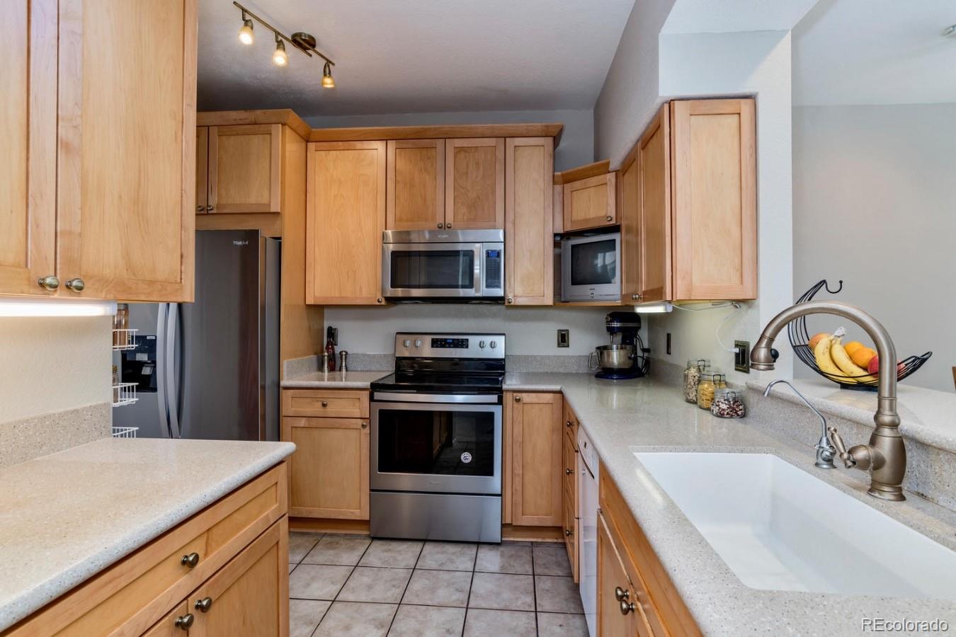 6486 Silver Mesa Drive, Unit B Highlands Ranch, CO 80130 - Photo 9 of 29 a kitchen with a sink stove and refrigerator