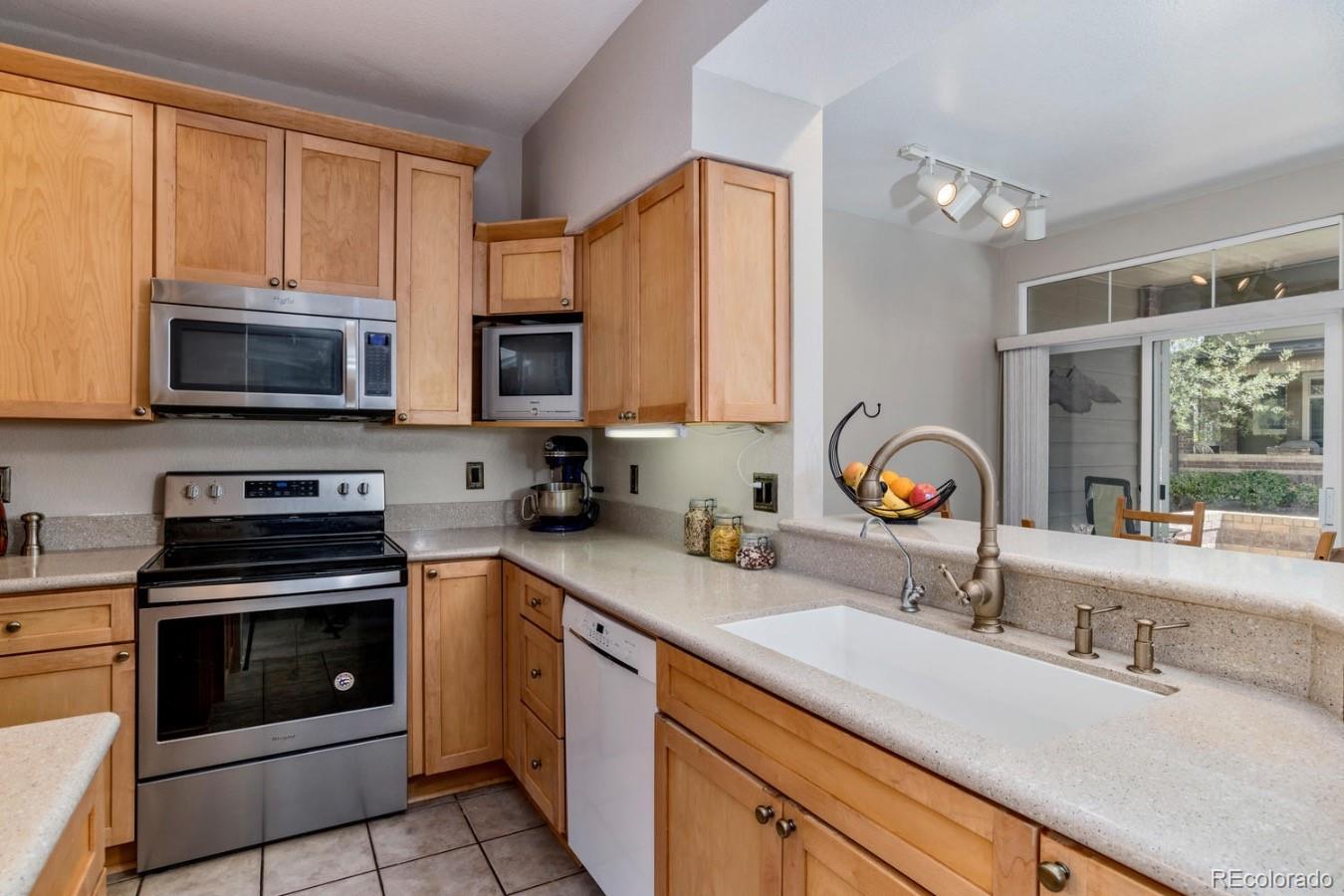 6486 Silver Mesa Drive, Unit B Highlands Ranch, CO 80130 - Photo 10 of 29 a kitchen with a sink stove and microwave