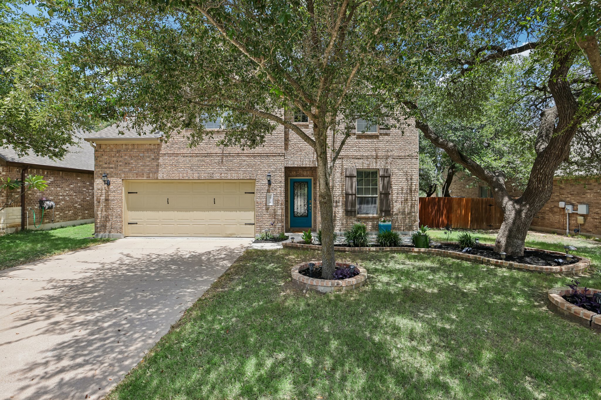 1924 Granite Springs Road Leander, TX 78641 - Photo 1 of 36 A well-maintained facade with mature trees provides ample shade to this charming brick residence.