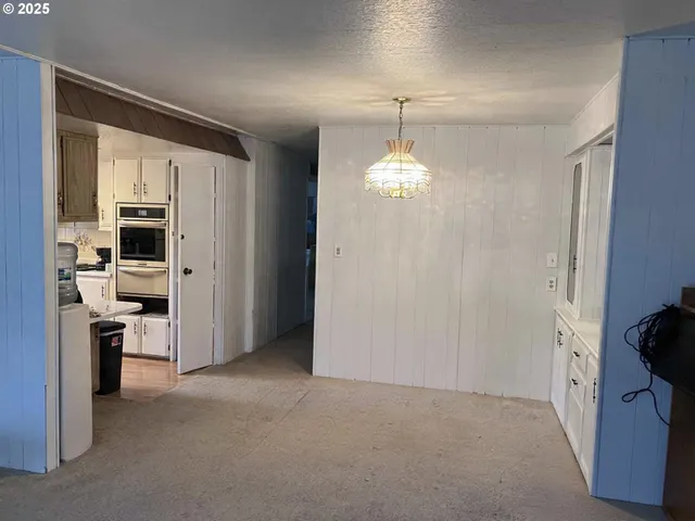 a view of a kitchen with a sink and dishwasher cabinets