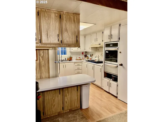 a kitchen with stainless steel appliances a sink and cabinets